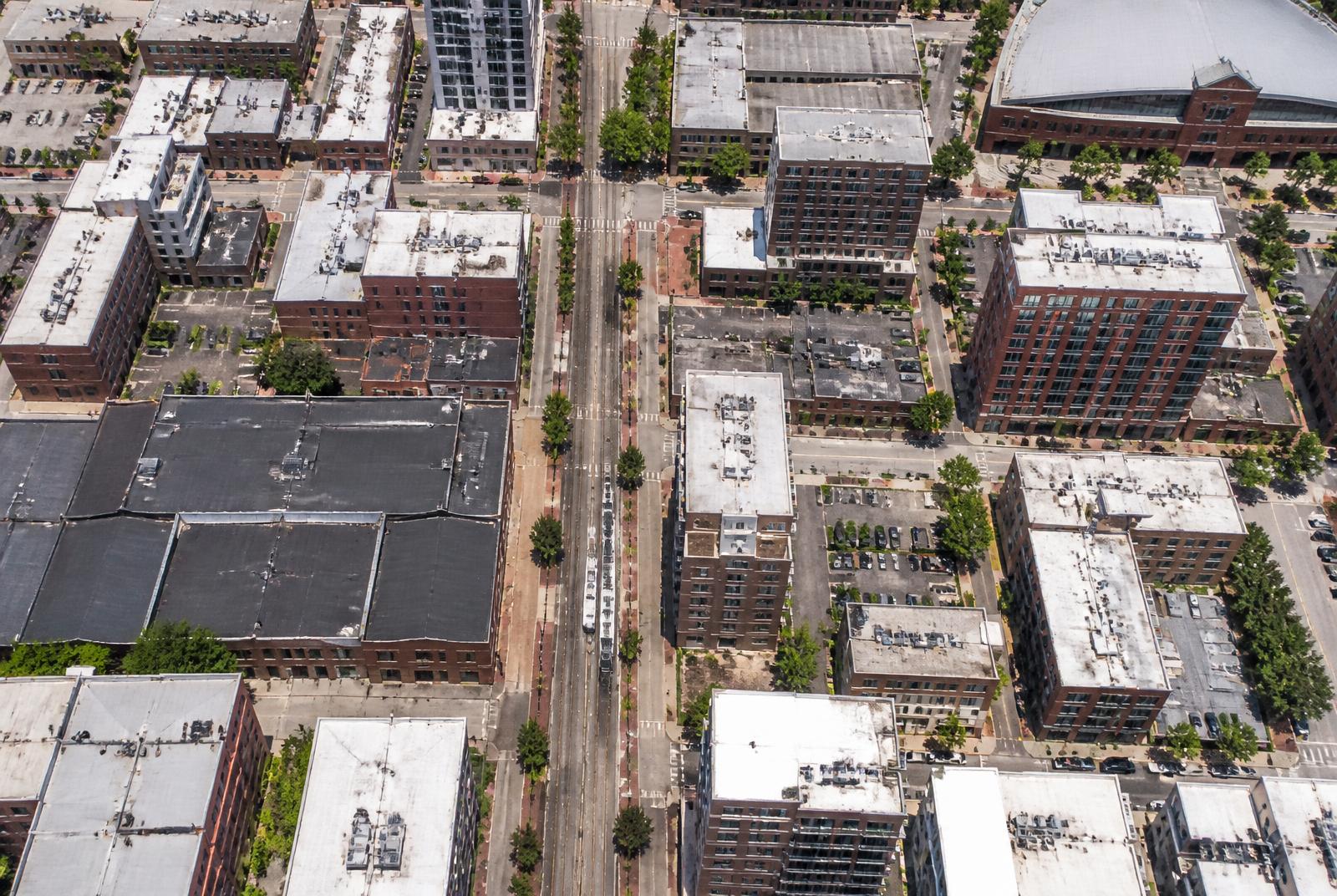 Overhead aerial view of the South End Charlotte street grid, warehouses, and light rail line