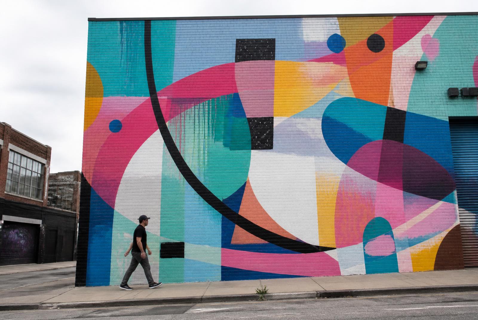 Large abstract mural on a brick warehouse wall in South End Charlotte