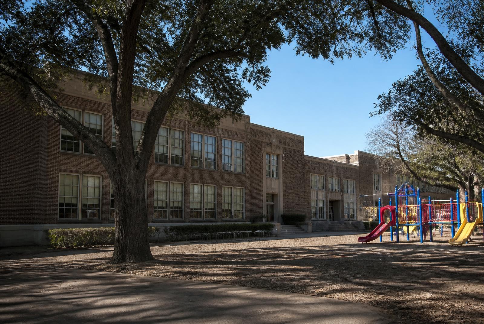 Brick public school campus with playground and shade trees near South End Charlotte