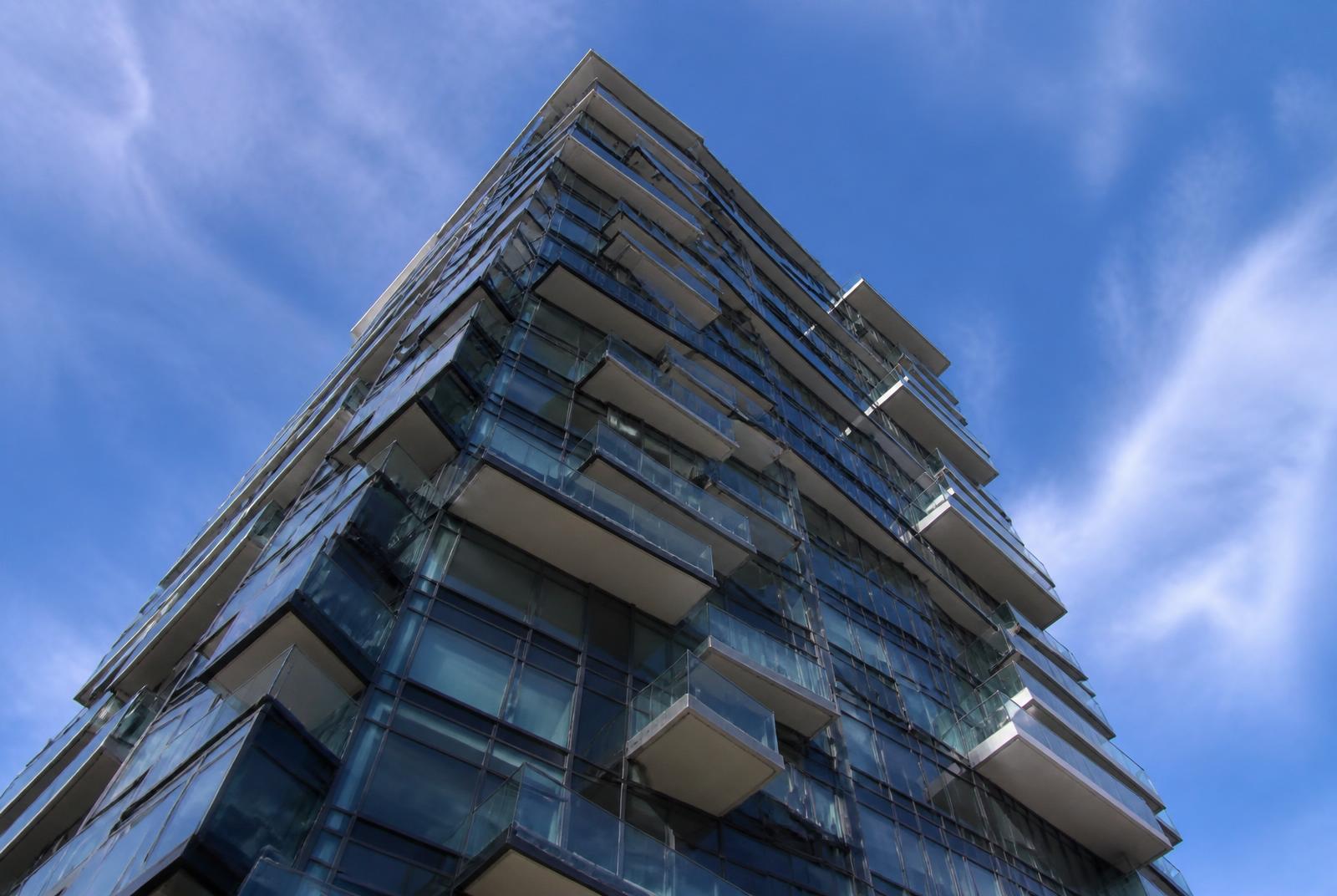 Modern glass high-rise condominium tower with staggered balconies in South End Charlotte